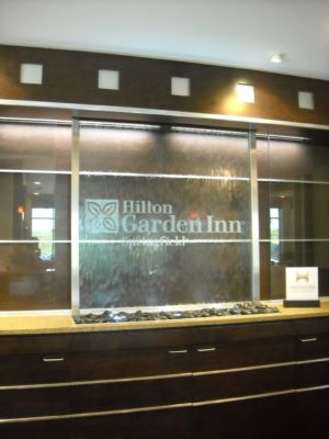 Hilton Garden Inn Springfield MO glass water wall with stainless frame water feature recessed in ceiling