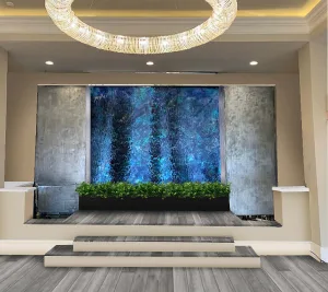 Frameless Glass Waterfall with Deep Blue Backgroun